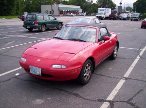 A red convertible with a license plate numbered MIDL1F