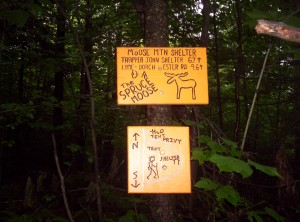 Welcome signs for Moose Mountain Shelter, clearly crafted by hand with a router, with a few rough illustrations of the lay of the site