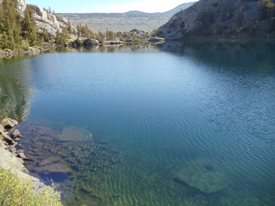 Looking across the eastern expanse of Garnet Lake toward its outlet, crossed by a barely-visible wooden bridge