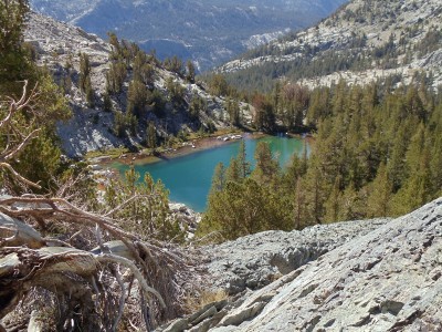 The teal lake is surrounded by rocky slopes sprinkled with evergreens