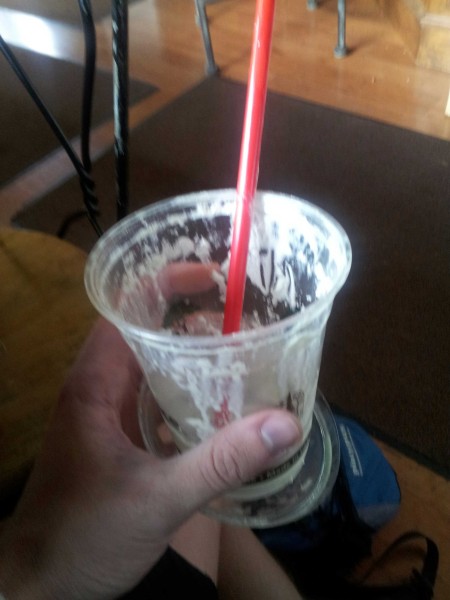 An empty plastic milk shake cup