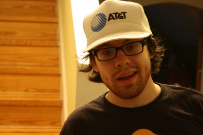 Andrew Auernheimer ("weev") wearing an old-school AT&T baseball cap